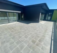 Spacious terrace at a 3-room apartment in the town of Svit with large glass doors.