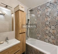 Bathroom in a 2-room apartment with mosaic tiles and modern furniture with a wooden decor.