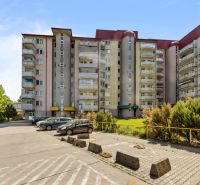 Residential building on Agátová Street in Bratislava - Dúbravka with a parking lot in the foreground.