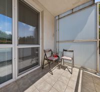 The balcony of a 3-room apartment on Agátová Street in Bratislava - Dúbravka with two chairs.