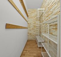 A narrow pantry with shelves, wooden slats, and a floor with a wooden decor in a 3-room apartment.