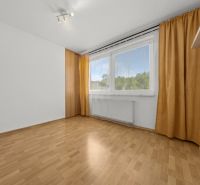 A room in a 3-room apartment with a wooden decor floor and yellow curtains.