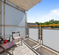 The balcony of a 3-room apartment on Agátová Street in Bratislava - Dúbravka with two chairs and a table.