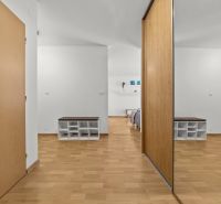 Interior of a 3-room apartment with wood-patterned flooring and a built-in wardrobe.