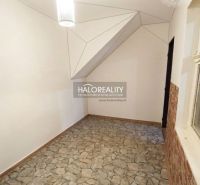 Living room in a 3-room apartment with a shelving unit and flooring with a wood decor.