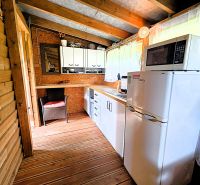 A cottage with a kitchen, wooden elements, and a floor with a wooden design, suitable for Košice.