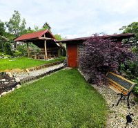A garden near a cottage in Košice - West district, with a bench and a gazebo.