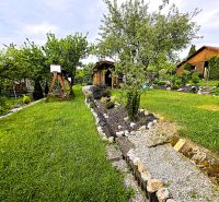 A cottage surrounded by a green garden and trees in Košice, in the district of Západ.