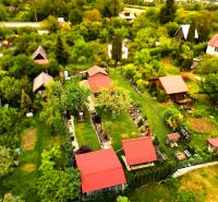 Aerial view of cottages and gardens surrounded by greenery in Košice - West district.