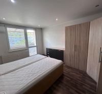 A bedroom with two mattresses and a wooden decor floor in a 3-room apartment.