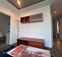 Living room in a 3-room apartment with a wooden decor floor and furniture.