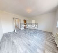 Living room in a two-room apartment with a wooden decor floor and simple lighting.