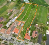 Residential plots in Veľké Úľany with a bordered plot between houses and nature.