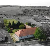 A family house in Čifár surrounded by a garden and the surrounding countryside.