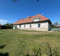 A family house in Čifáre with a large garden and a brick roof under a blue sky.