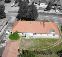 A family house in Čifáre with a reddish roof and a green yard.