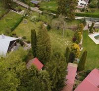 Aerial view of cottages in Nižný Klátov with a pool and gardens.
