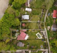 Aerial view of a cottage in Nižný Klátov surrounded by greenery and land.