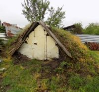 Garden shed in Gbelce near the family house, covered with grass and soil.