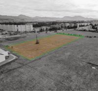 Development plots in Martin with views of apartment buildings and surrounding mountains.