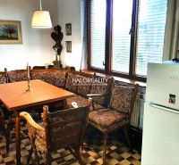 A dining room in a family house with a corner bench and checkered floor, decorations on the walls.