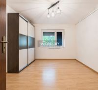 A room in a family house with a wooden decor floor and a built-in wardrobe.