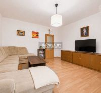 Living room in a family house with a corner sofa and a wooden decor floor.