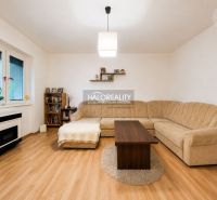 Living room in a family house with a corner sofa and a wooden decor floor.