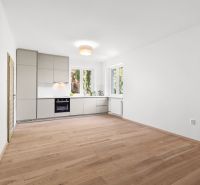 A kitchen with a wood-patterned floor in a 3-room apartment, a bright room with built-in appliances.