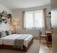 Bedroom with a bed, a desk, and a wooden decor floor in a family house.