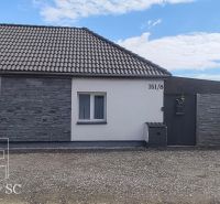 The family house on Mlynska Street in Blatne has a white facade and stone cladding.