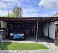 A garage with a car at a family house on Mlynska Street in Blatne.