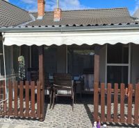 The terrace of a family house on Mlynska Street in Blatné with a wooden fence and a shelter.