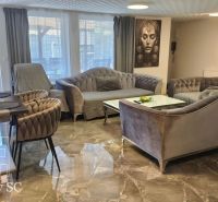 Living room in a family house with a comfortable sofa and marble floor.