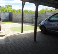 Carport at a family house on Mlynska Street in Blatne with a paved area.