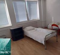 In the production premises, there are two beds, a shelf, and a floor with a wooden decor.