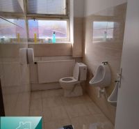 A toilet with tiles and ceramic flooring in industrial production areas.