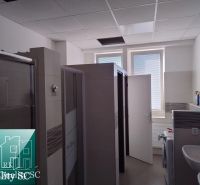 Bathroom with shower stalls and a sink in warehouse and hall spaces.