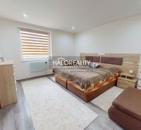 A bedroom in a family house with a wooden decor floor and cozy furnishings.