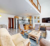 A family house with a wooden decor floor, spacious living room, and dining area.