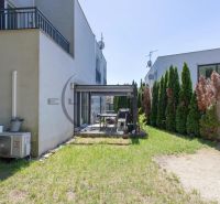 The backyard of a family house in Stupava with a terrace and lawn.