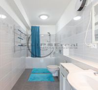 A bathroom in a family house with a bathtub and blue accessories.