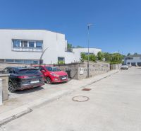 A street with family houses in Stupava, parked cars, clear weather.