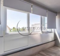 Glazed balcony with blinds and a view in a family house in Stupava.