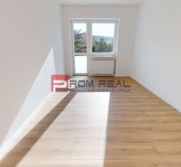 A bright room with white walls and a wooden decor floor in a family house.