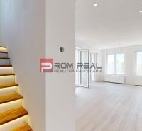 Interior of a family house with illuminated staircase and wooden decor flooring.
