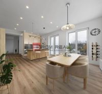 Dining room with kitchen in a family house, table, chairs, bar, and floor with wooden decor.