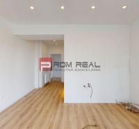 The interior of a family house with white walls, a floor with a wooden decor, ready for installation.