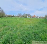 Gardens in Hruboňovo with expansive grassy areas and rural houses in the background.