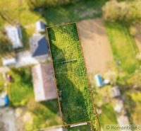 Aerial view of the gardens in Hruboňovo with a vast green lawn in the center.